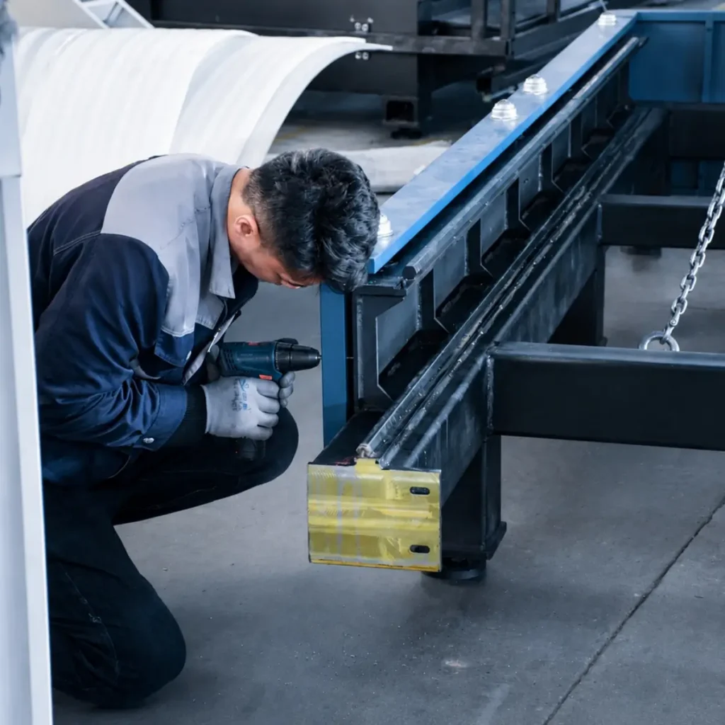 Technician checking parts during laser cutting machine assembly