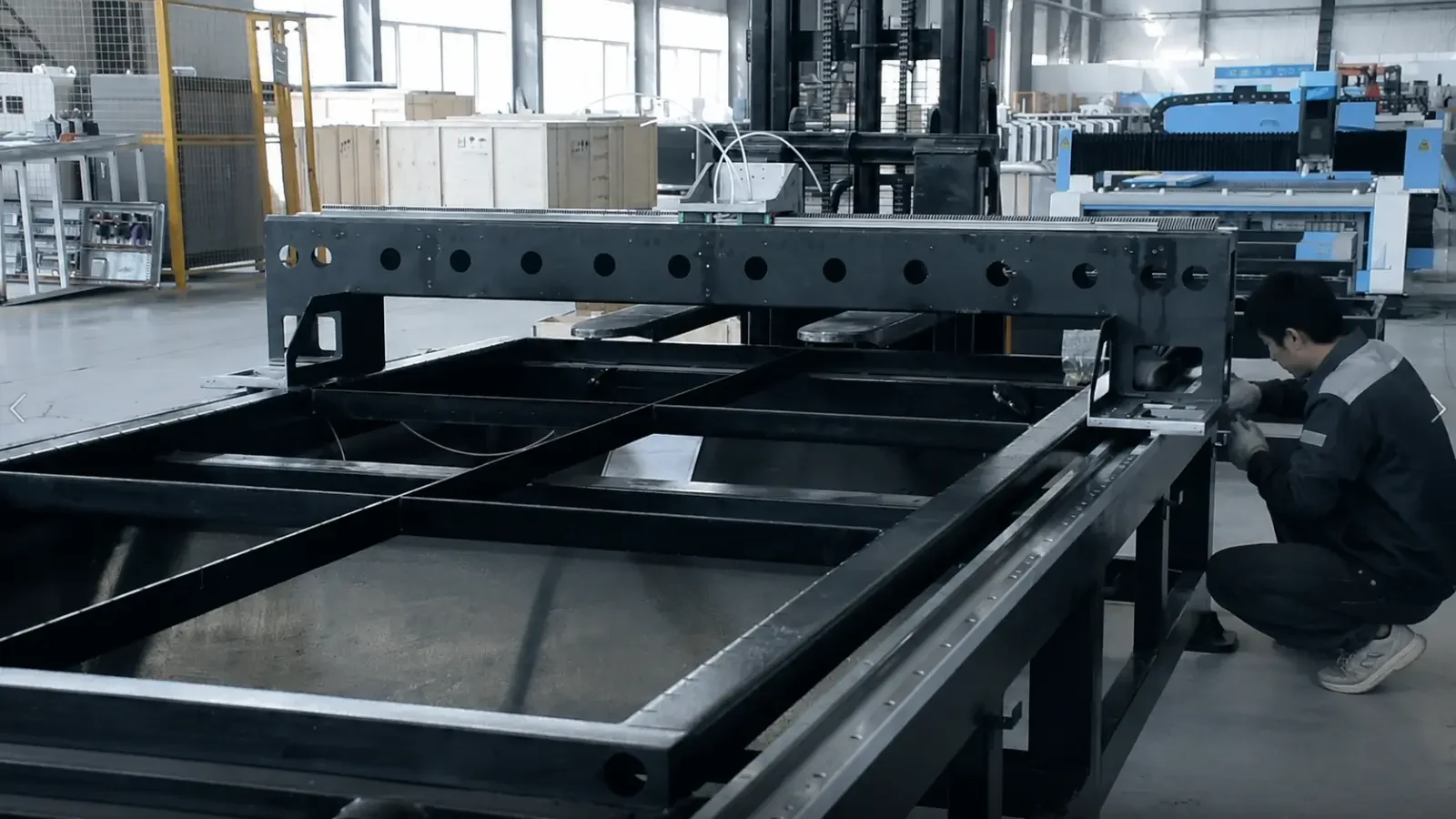 Technician assembling a laser cutting machine frame